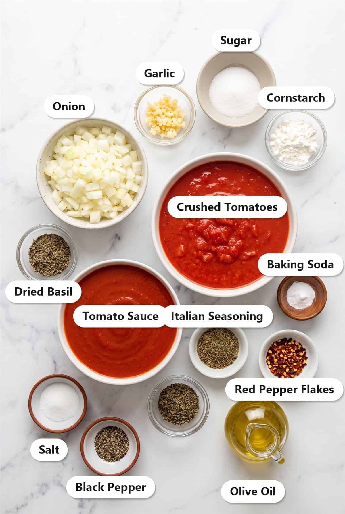 Labeled ingredients for Homemade Pasta Sauce: crushed tomatoes, tomato sauce, onion, garlic, olive oil, dried basil, Italian seasoning, and seasonings.