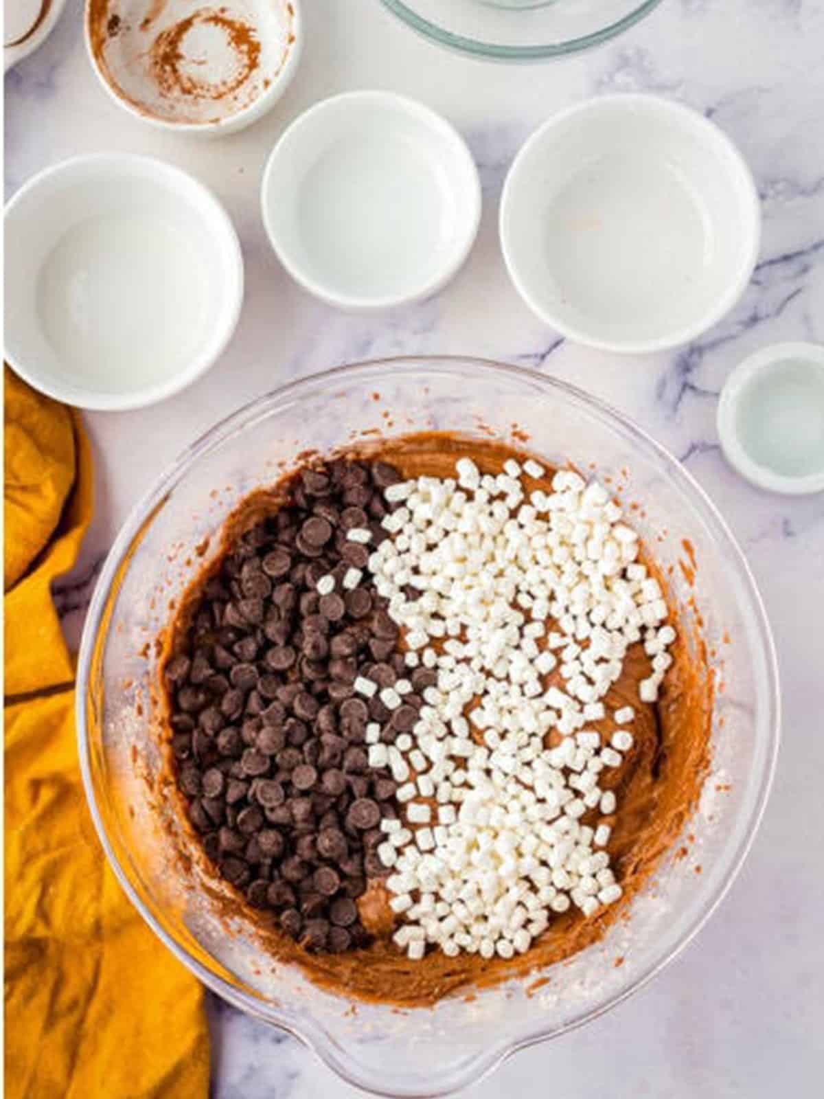 Chocolate chips and marshmallow bits folded into the hot chocolate cake batter.