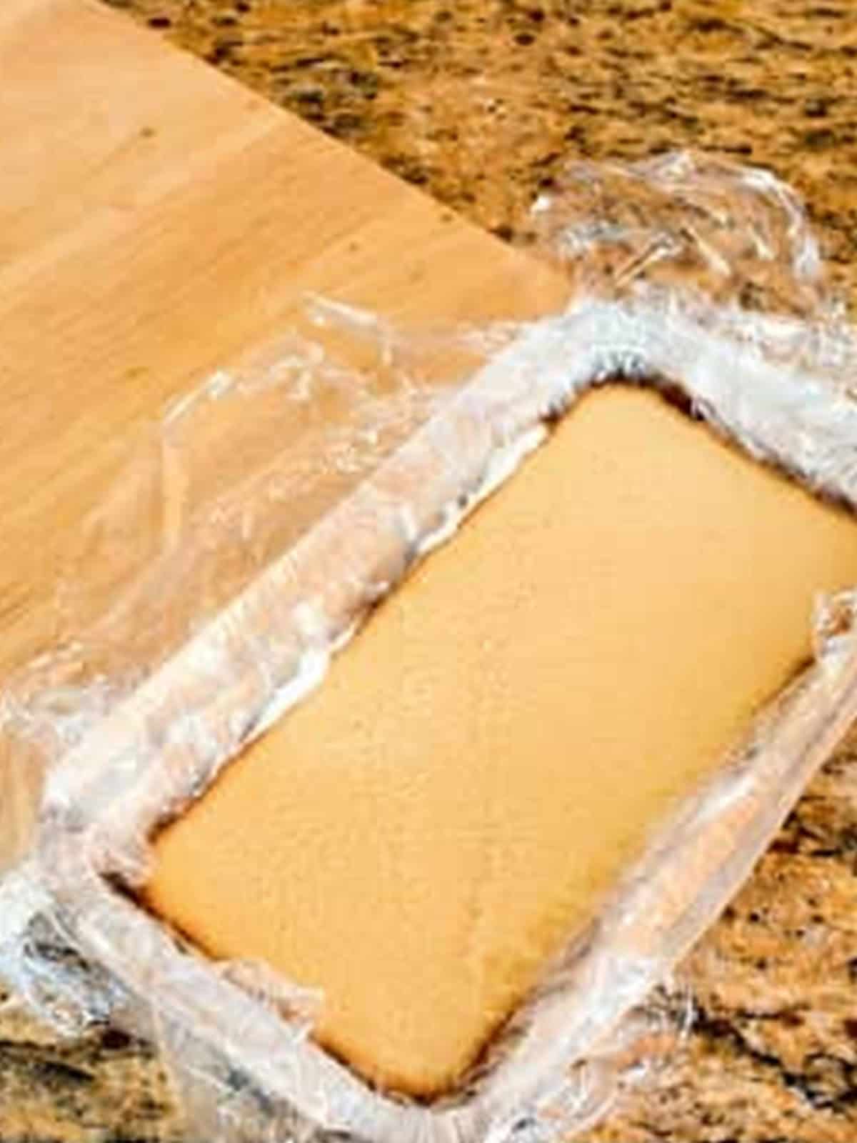 Middle cake layer placed on top of the ice cream layer while assembling hot fudge sundae cake.