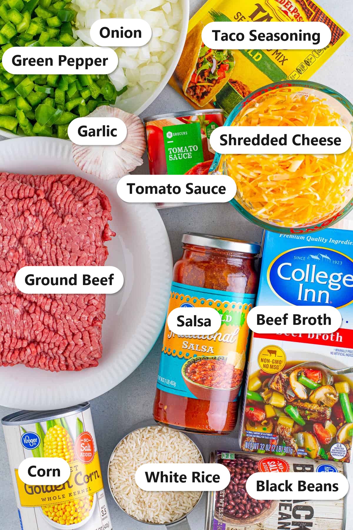 Labeled ingredients to make Mexican rice casserole including ground beef, white rice, black beans, corn, shredded cheese, salsa, and taco seasoning