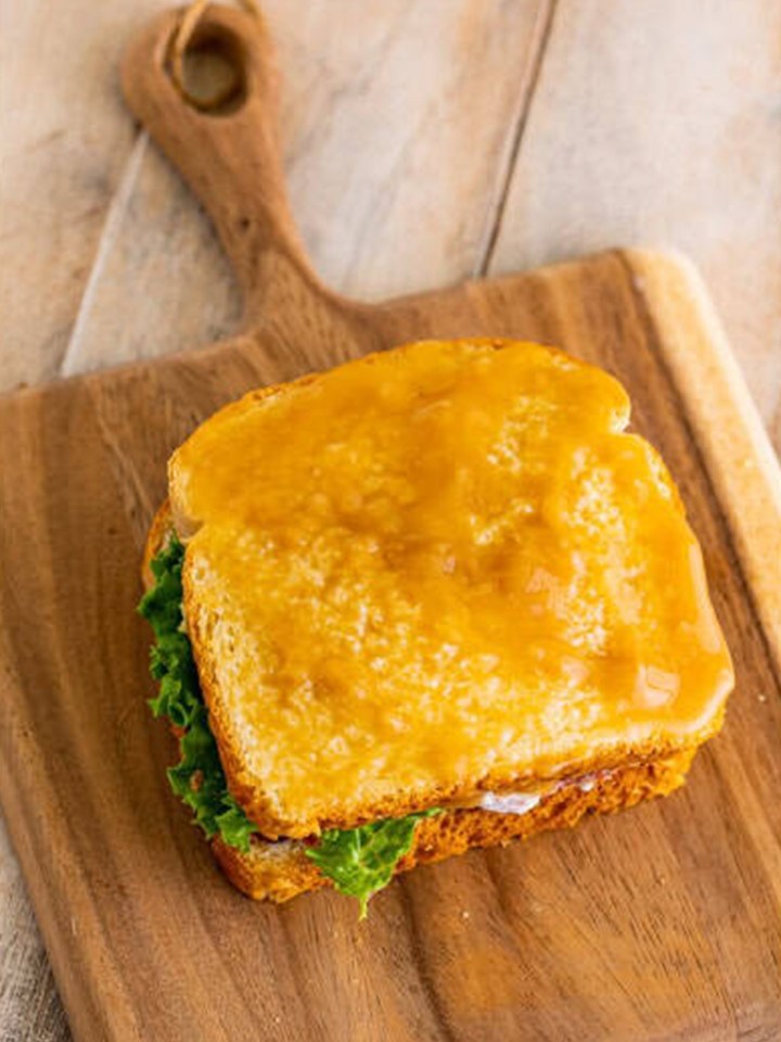The gravy soaked moistmaker slice of bread placed on the leftover turkey sandwich.