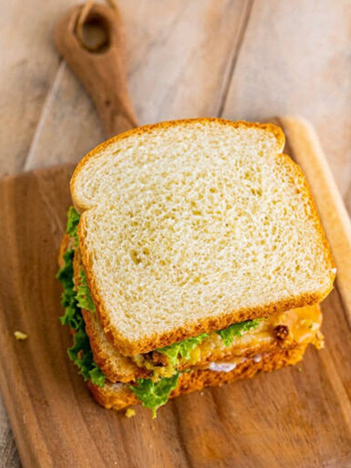 The assembled leftover turkey sandwich layers before the top slice of bread goes on.