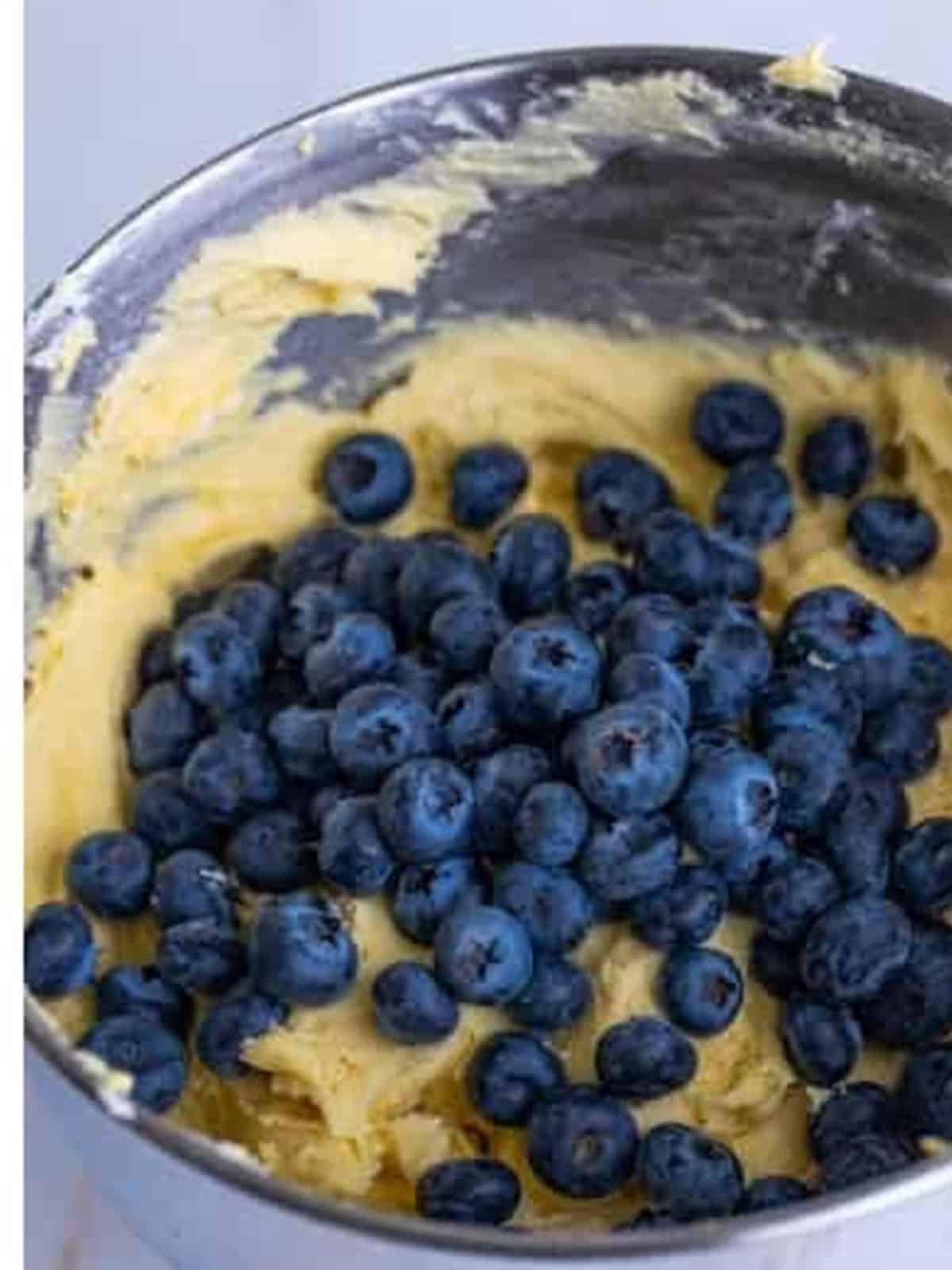 Folding fresh blueberries into the lemon pound cake batter.
