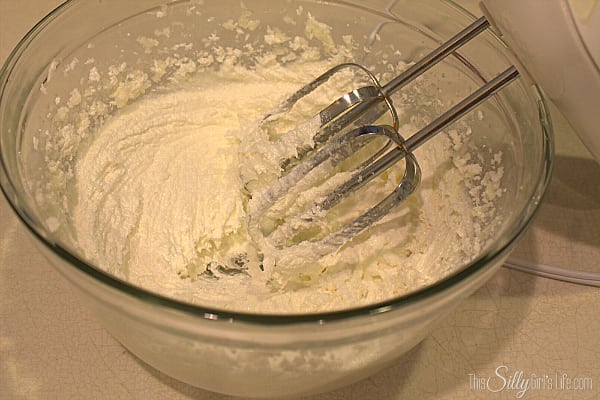 Butter and sugar creamed until light and fluffy in a glass bowl with a hand mixer.