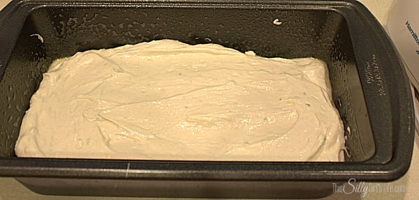 Lemon lime cake batter smoothed into a loaf pan ready for the oven.