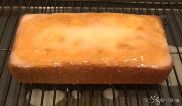 Lemon lime glaze poured over the cooled cake on a wire rack.