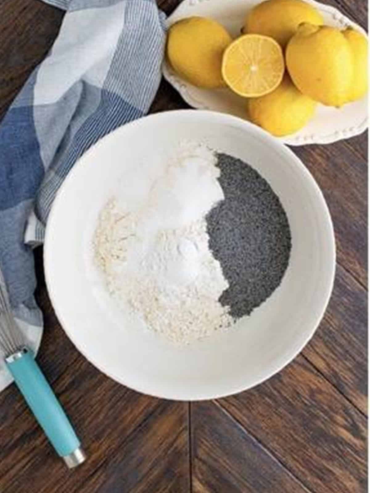 Flour, poppy seeds, sugar, baking powder, and salt in a bowl to whisk together for lemon poppy seed pancakes.