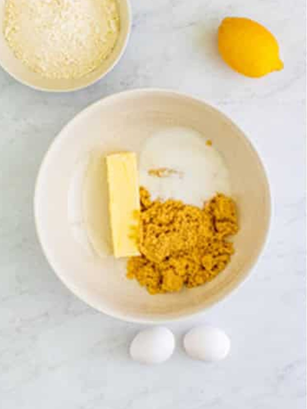 Butter, brown sugar, and granulated sugar creamed together in a bowl for lemon poppyseed bars.