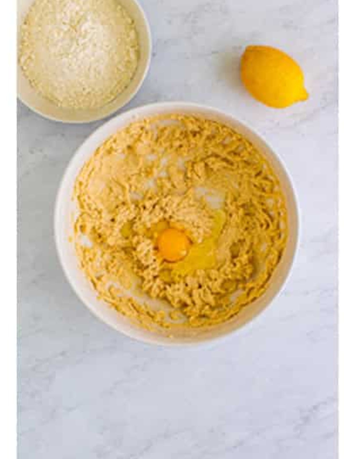 Eggs, lemon juice, and zest beaten into the creamed butter and sugar.