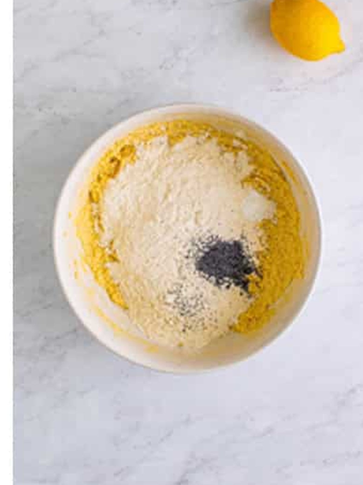 Flour, poppy seeds, and baking powder added to the lemon bar batter.