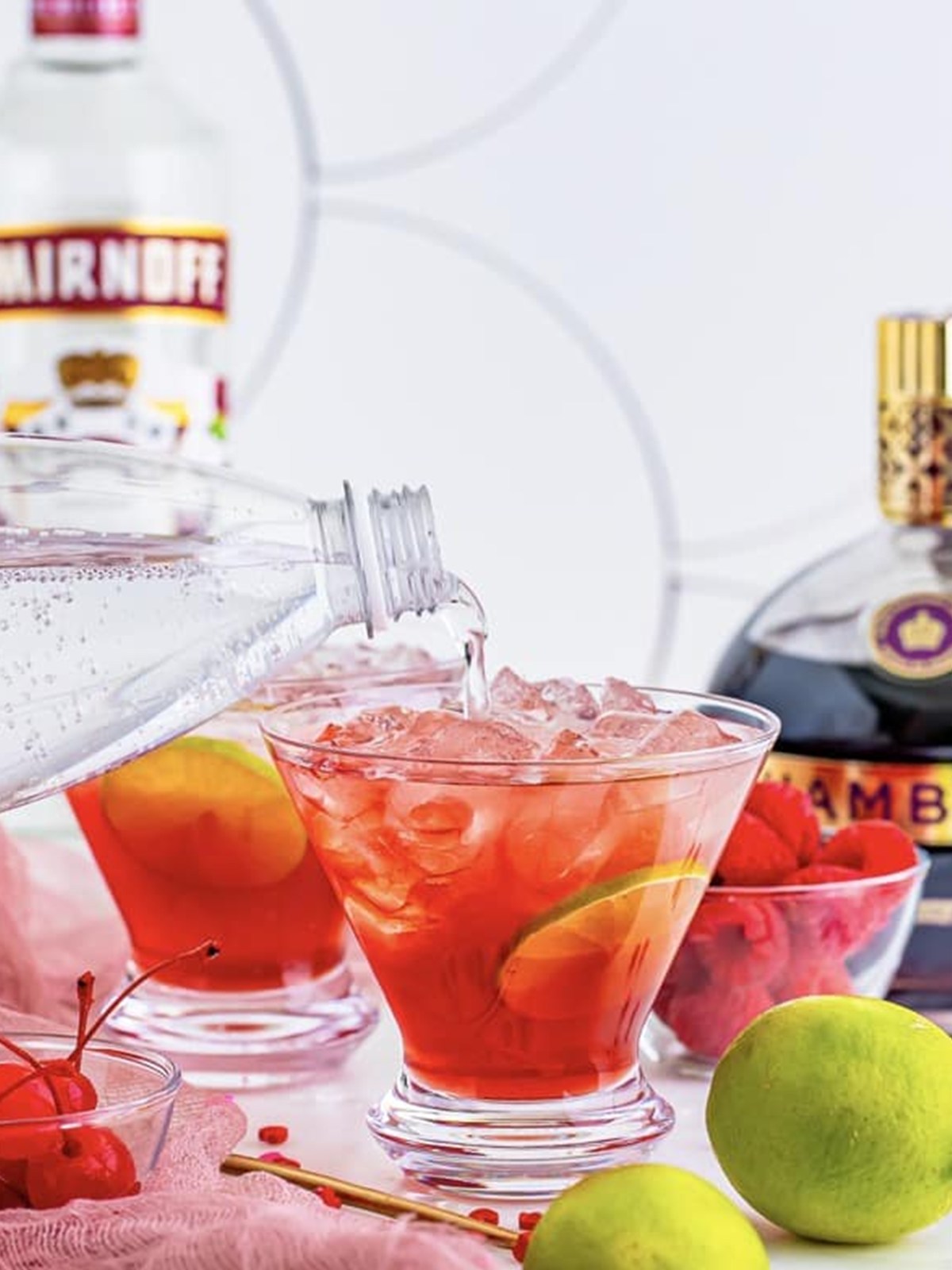 Club soda topped over a love potion cocktail in a glass.