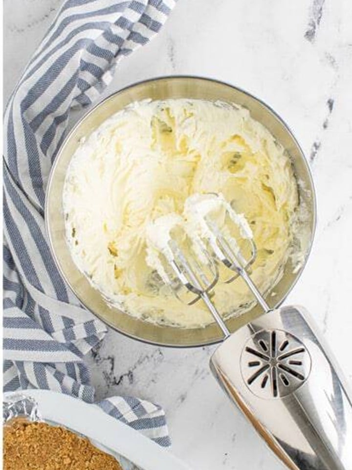 Cream cheese whipped smooth with a hand mixer for the maple cheesecake filling.