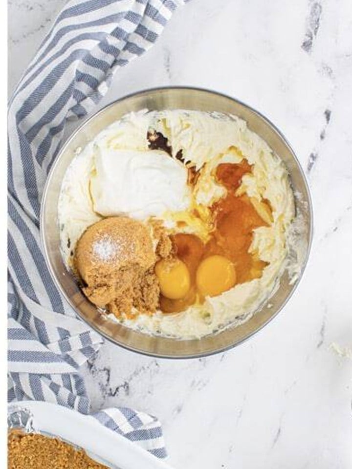 Maple syrup, brown sugar, sour cream, eggs, flour, and extract added to the whipped cream cheese.