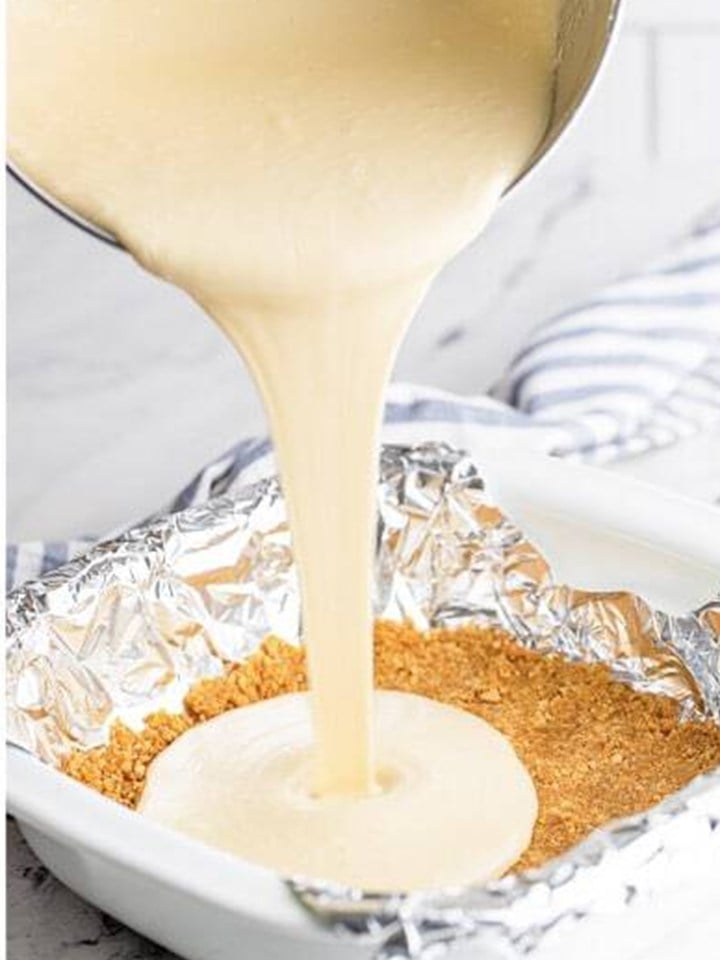 The maple cheesecake filling poured over the graham cracker crust in the pan.