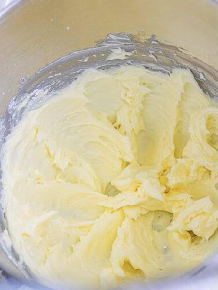 Softened butter creamed until smooth in a stand mixer bowl for maple frosting.