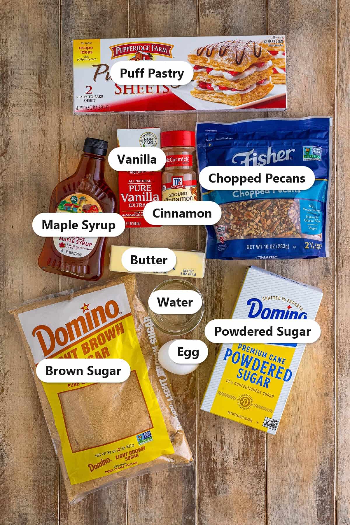 Labeled ingredients for Maple Pecan Pastry Braid including puff pastry, chopped pecans, maple syrup, brown sugar, butter, and cinnamon.