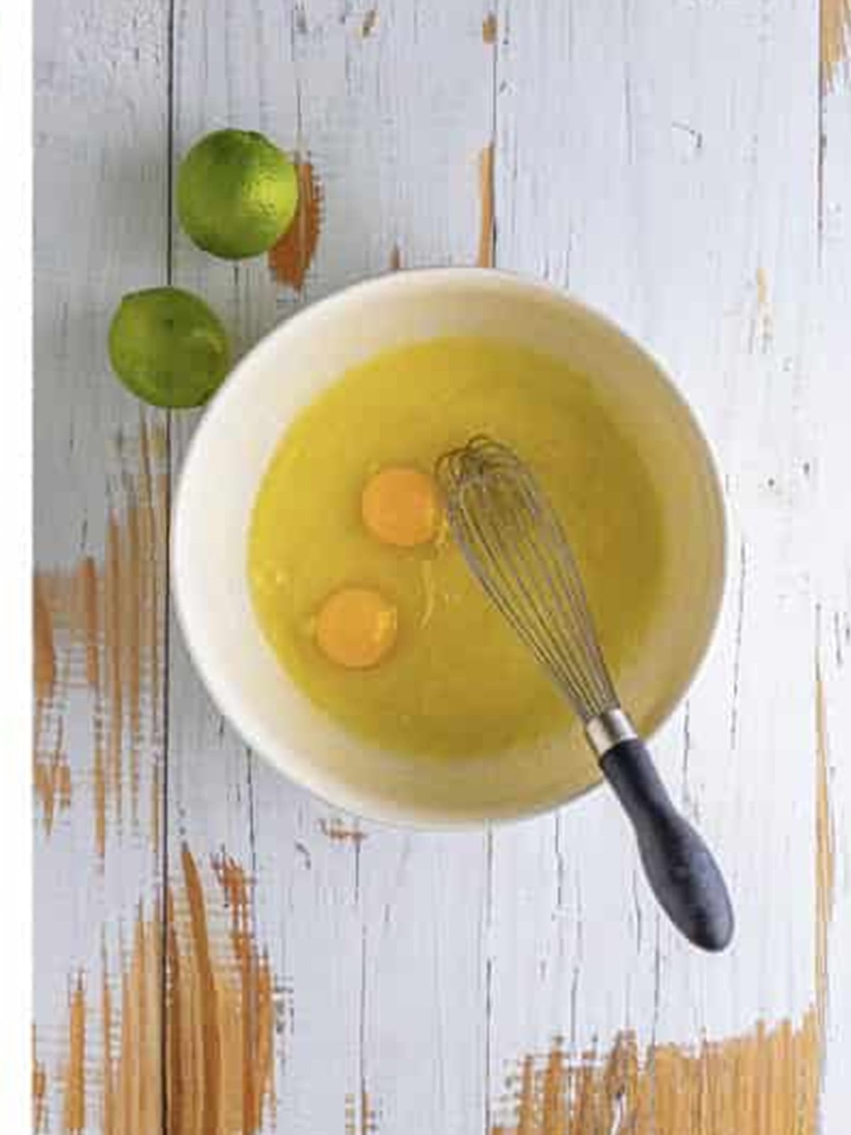 Whisking eggs into the butter and sugar mixture.