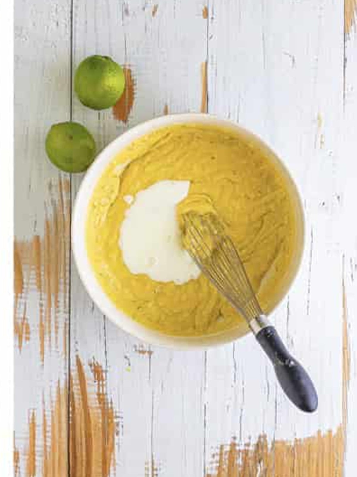 Whisking buttermilk into the lime cupcake batter.