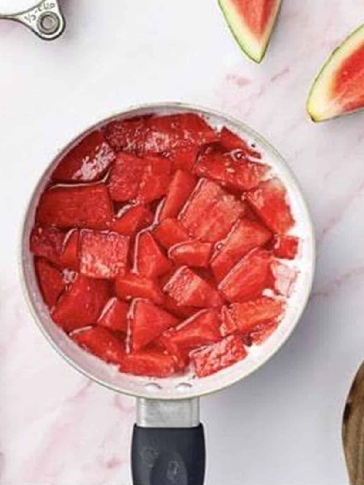 Diced watermelon simmering in simple syrup for the Melon Cocktail.