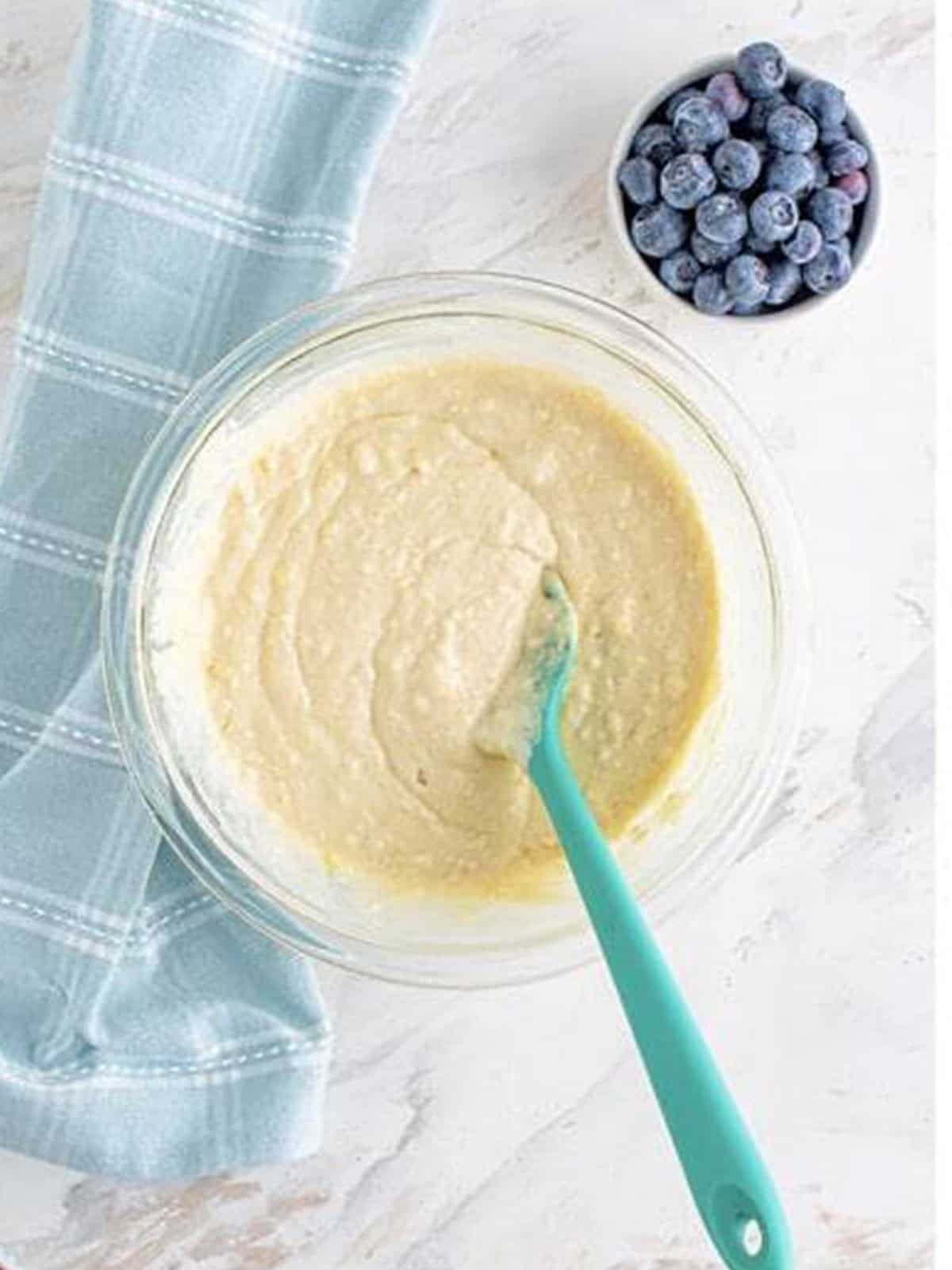 Smooth pancake batter mixed together in a glass bowl.