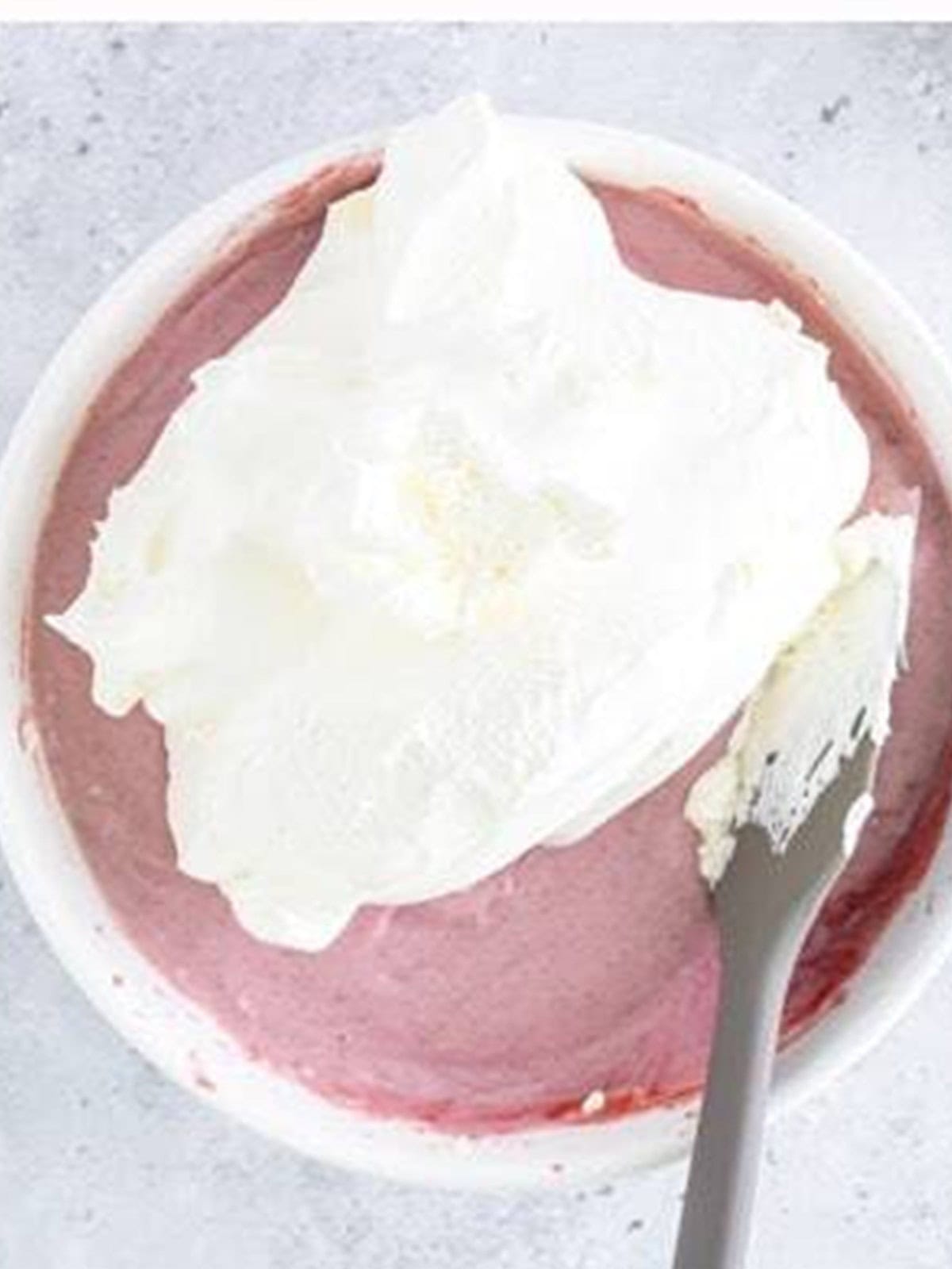 Whipped topping folded gently into the raspberry cheesecake filling for mini lemon cheesecakes.