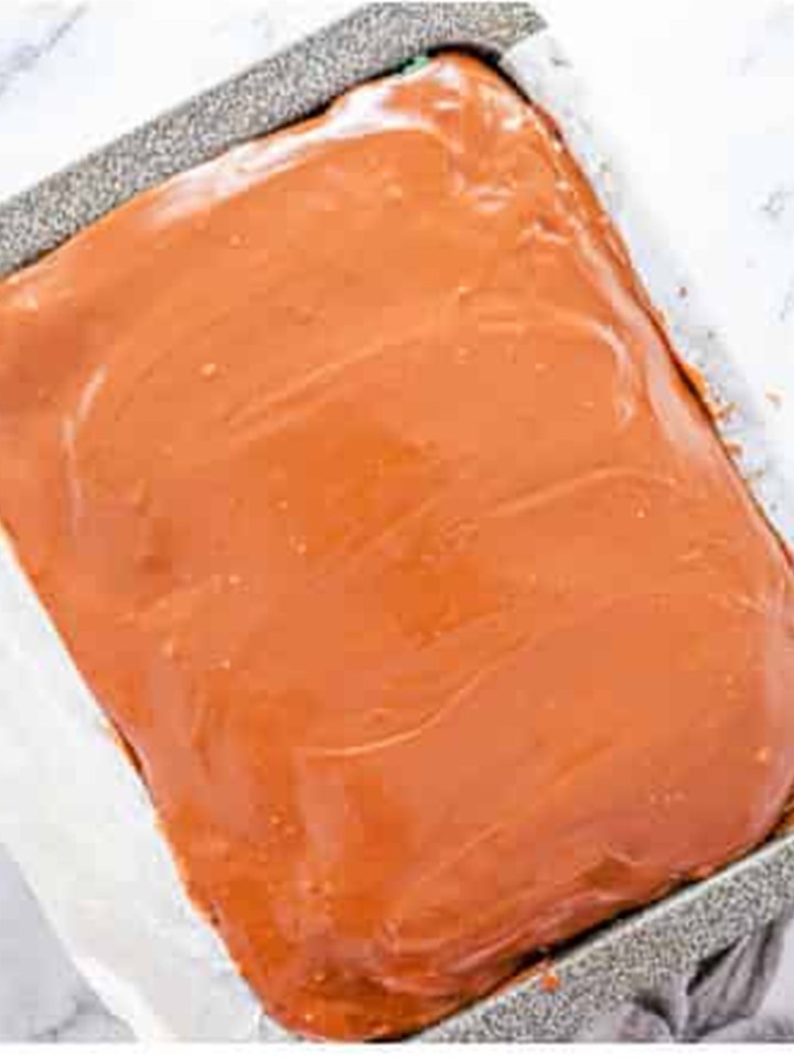 Milk chocolate fudge frosting poured and smoothed over the mint layer.