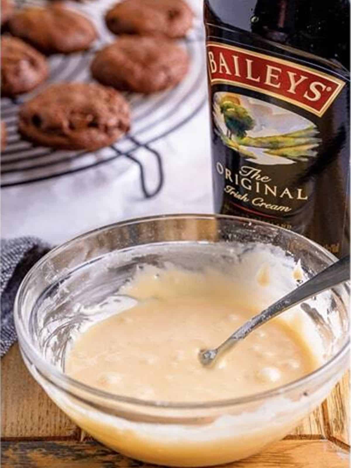 Baileys glaze whisked together in a bowl for mudslide cookies.