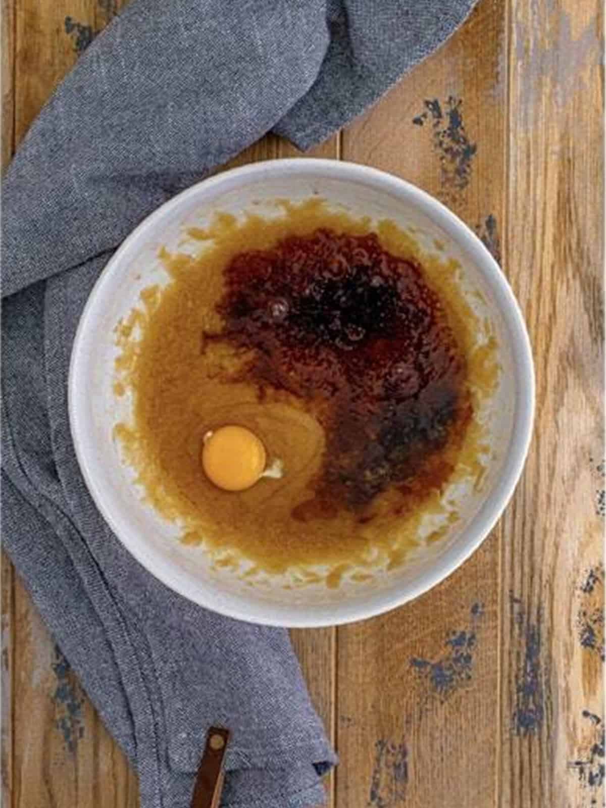 Melted butter, sugars, egg, and Kahlua mixed together in a bowl.