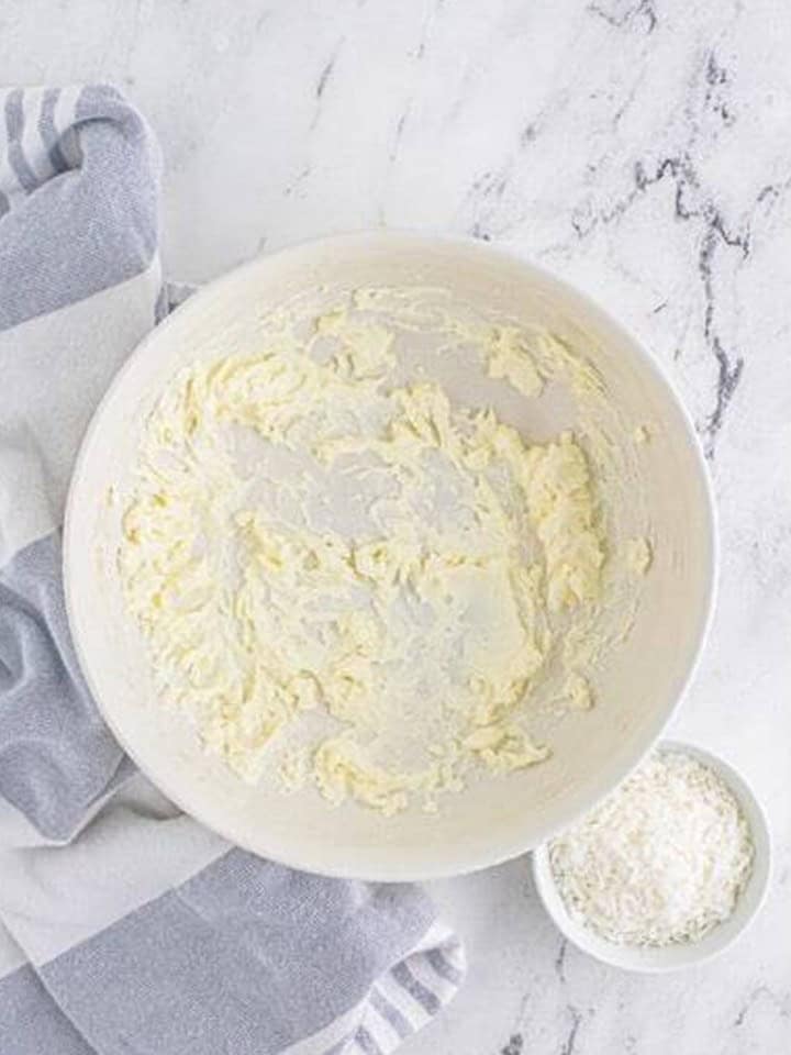 Cream cheese whipped smooth in a white bowl for the coconut cream pie filling.