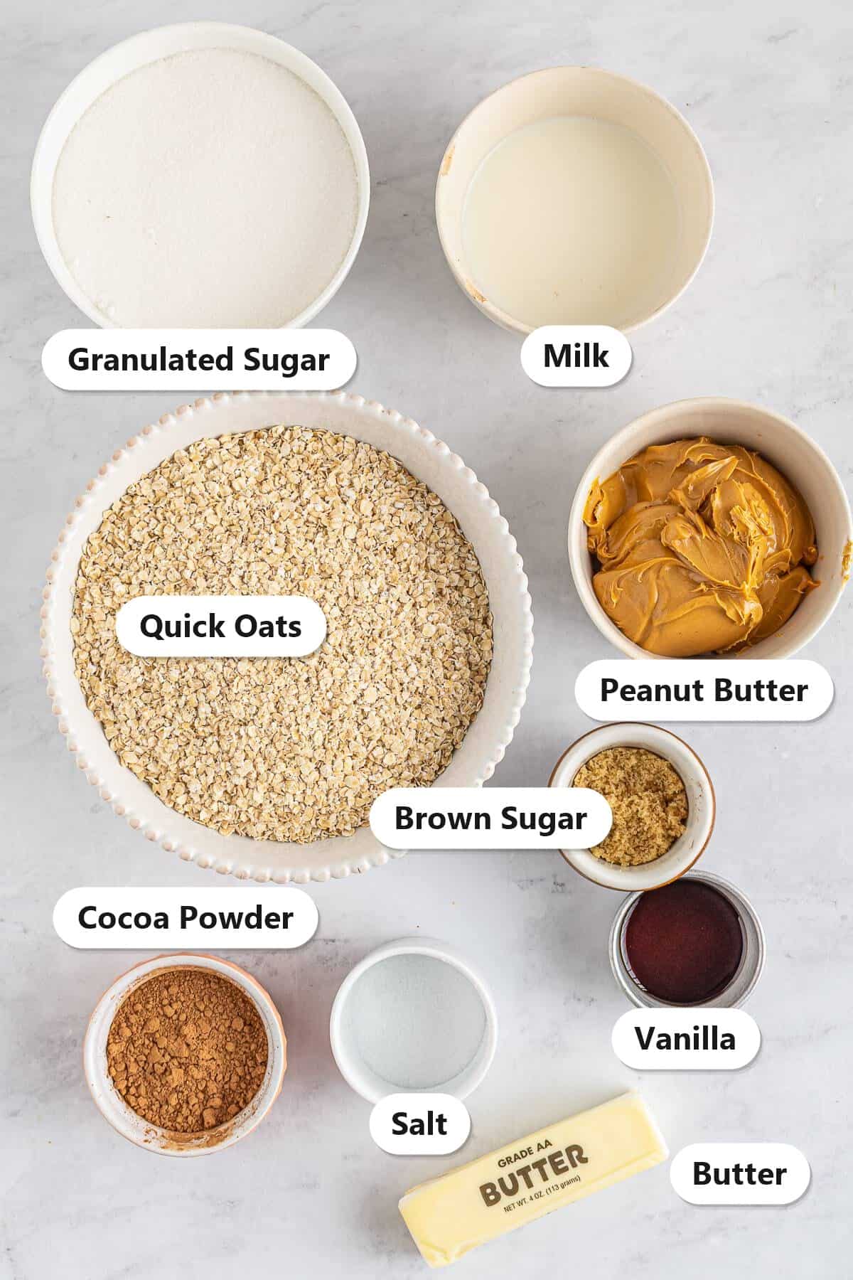 Labeled ingredients for No Bake Cookies including quick oats, peanut butter, cocoa powder, sugar, brown sugar, milk, butter, vanilla, and salt.