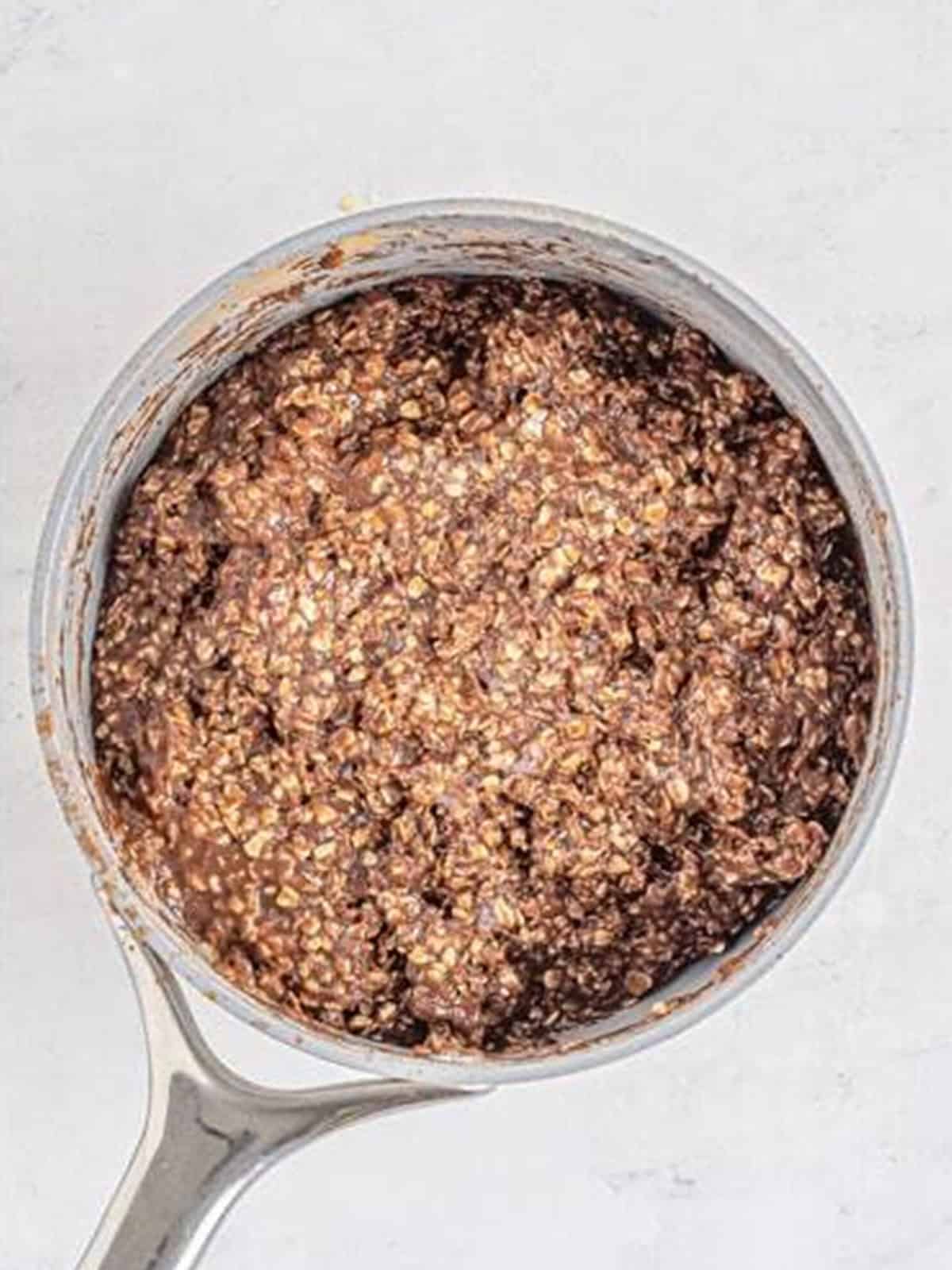 Oats stirred until fully coated in the chocolate peanut butter mixture.