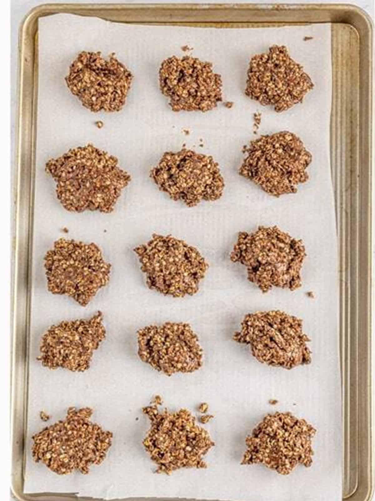 No Bake Cookies scooped into mounds on a parchment lined baking sheet to set.