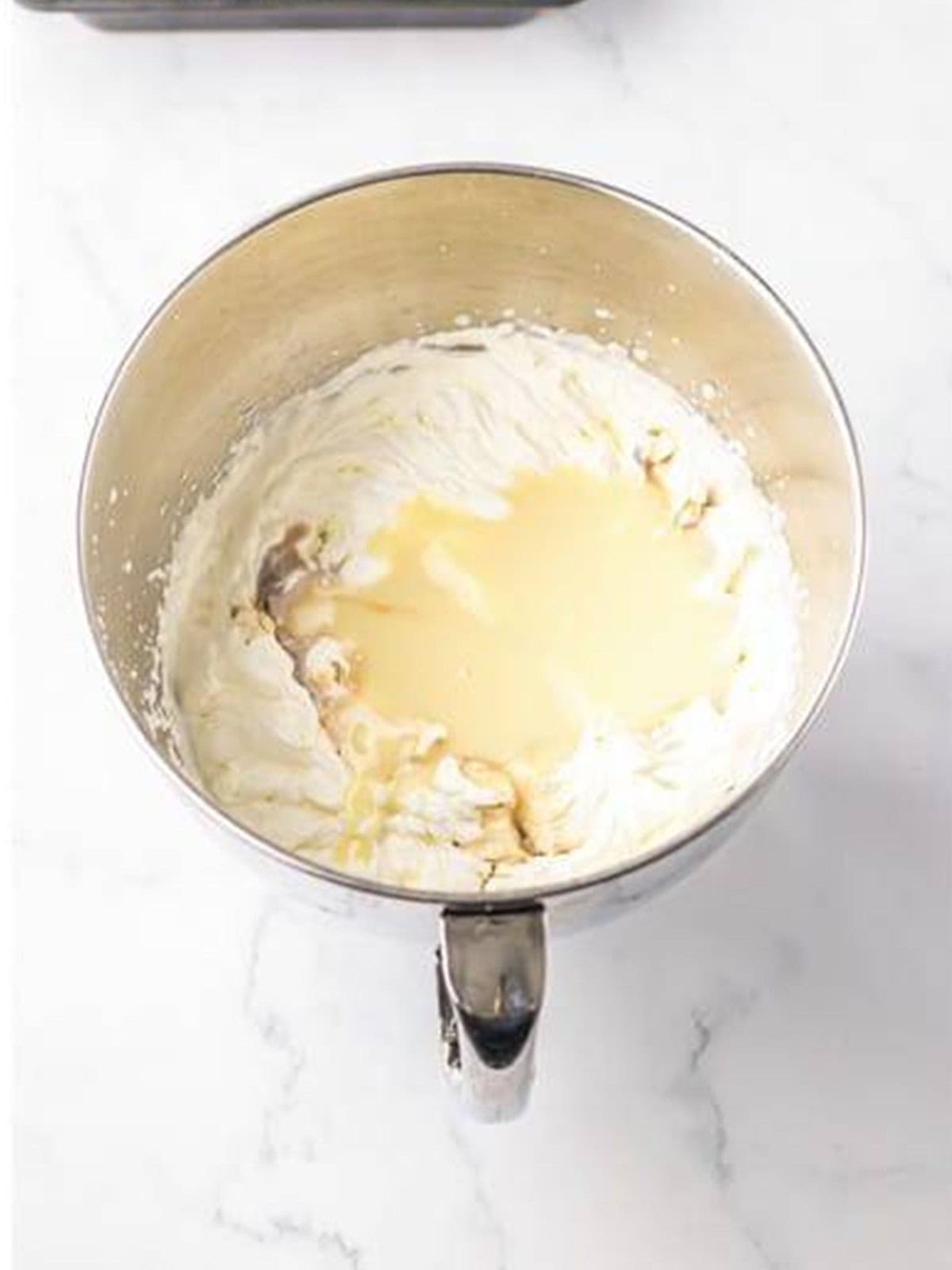 Sweetened condensed milk folded into the whipped cream for the ice cream layer.