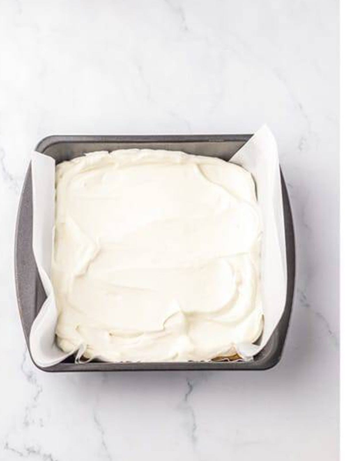 The no churn ice cream mixture spread evenly in the pan.