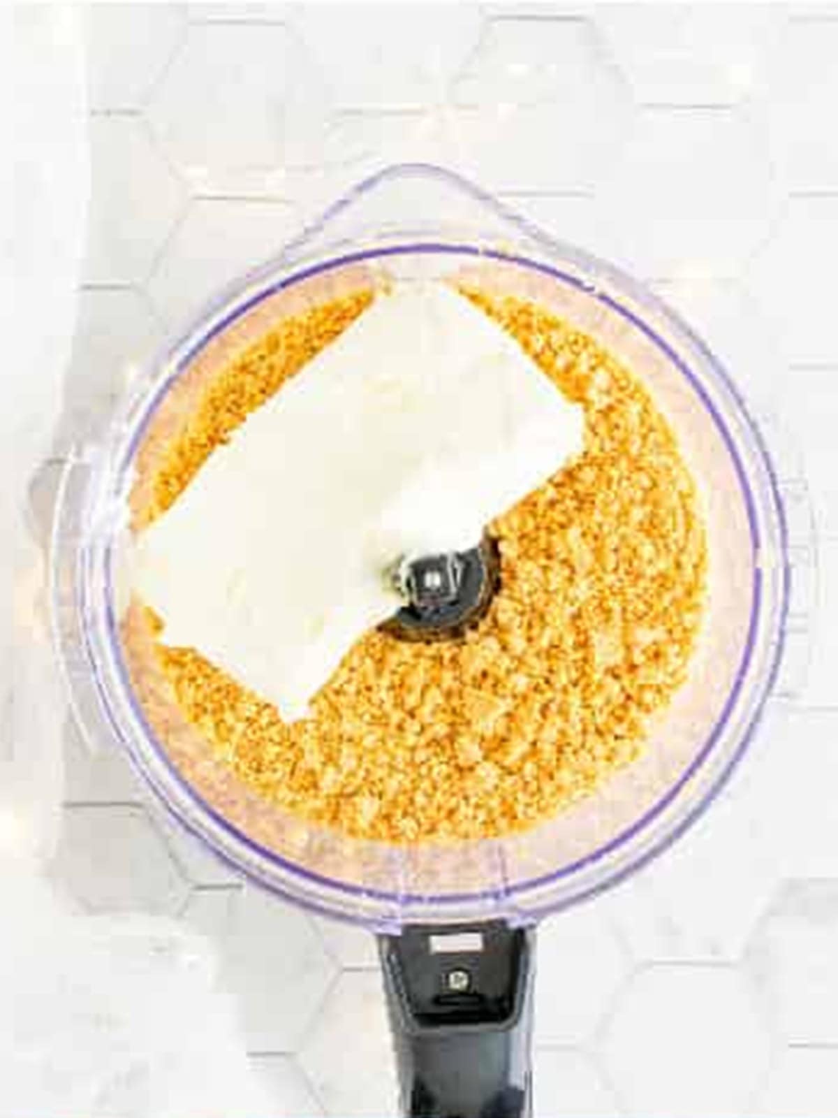 Cream cheese added to golden Oreo crumbs in a food processor for Oreo Balls.