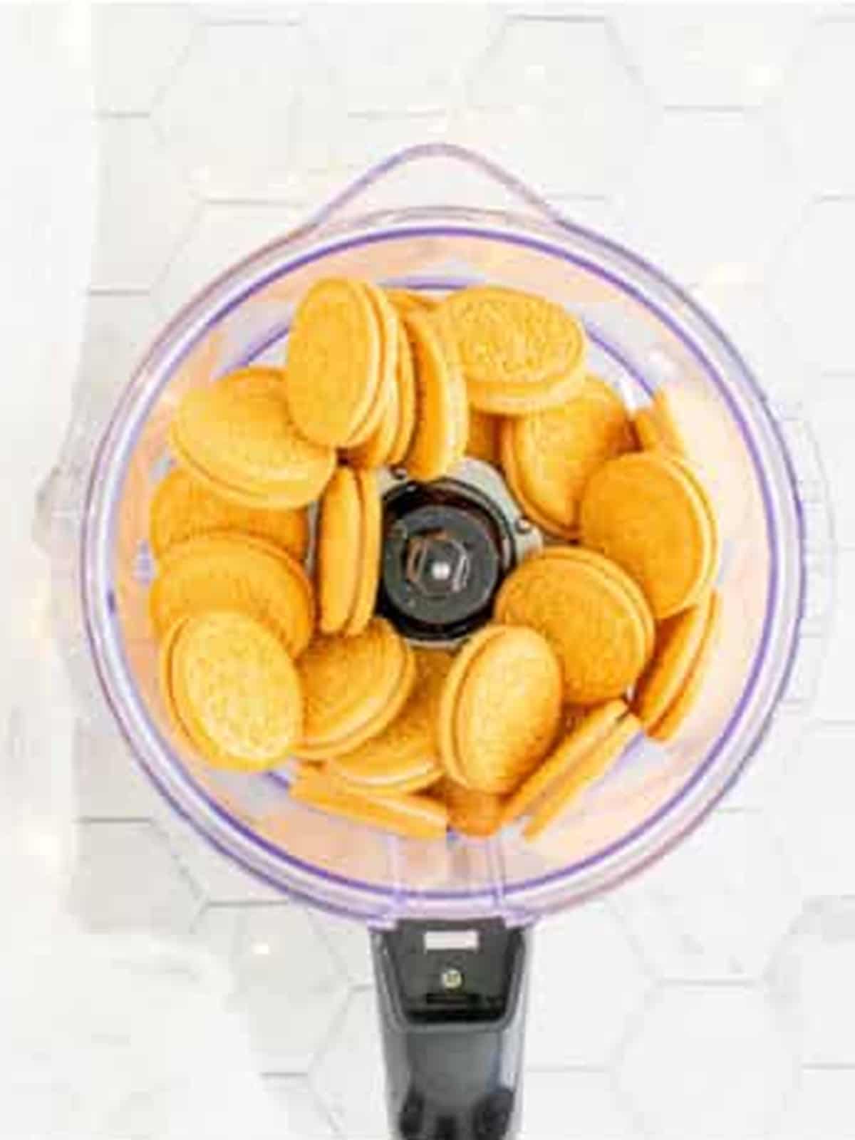 Golden Oreos in a food processor ready to be crushed for Oreo Balls.