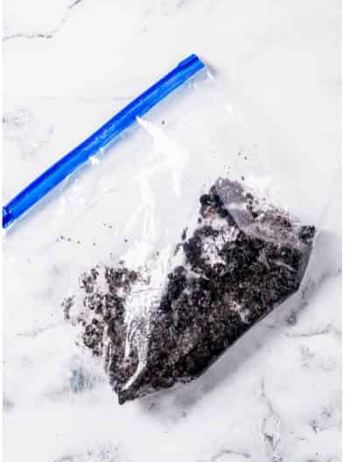 Crushing Oreos into chunks inside a ziplock bag for the Oreo Brownies topping.