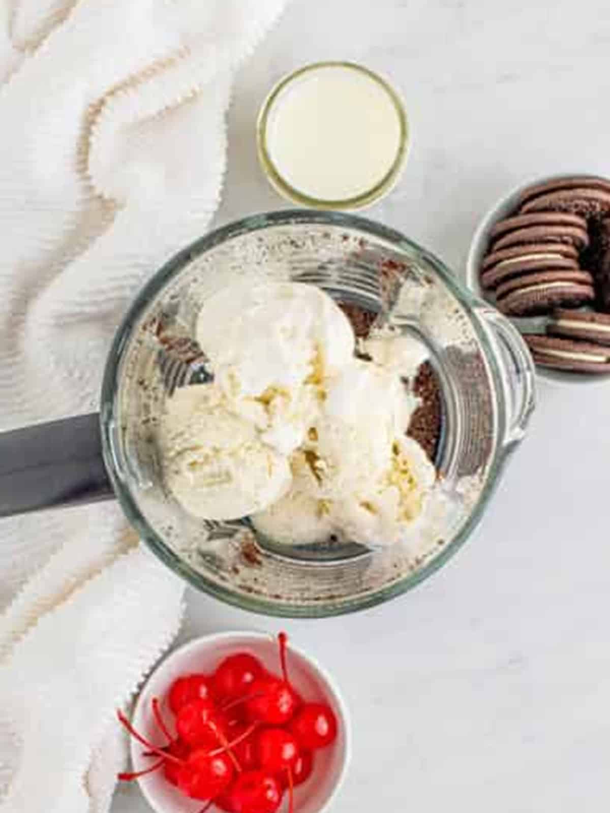Scoops of vanilla ice cream added to the cookie crumbs in the blender.