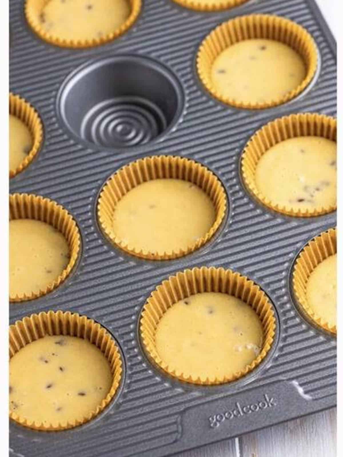 Pancake cupcake batter portioned into a lined cupcake tin.
