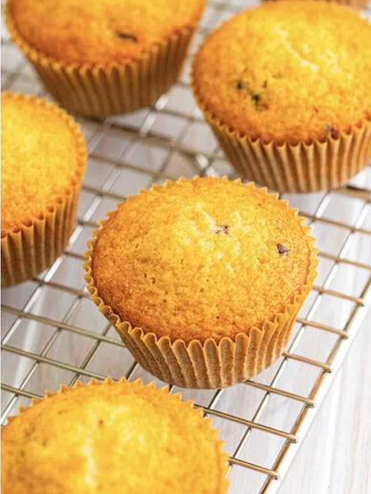 Baked pancake cupcakes cooling on a wire rack.