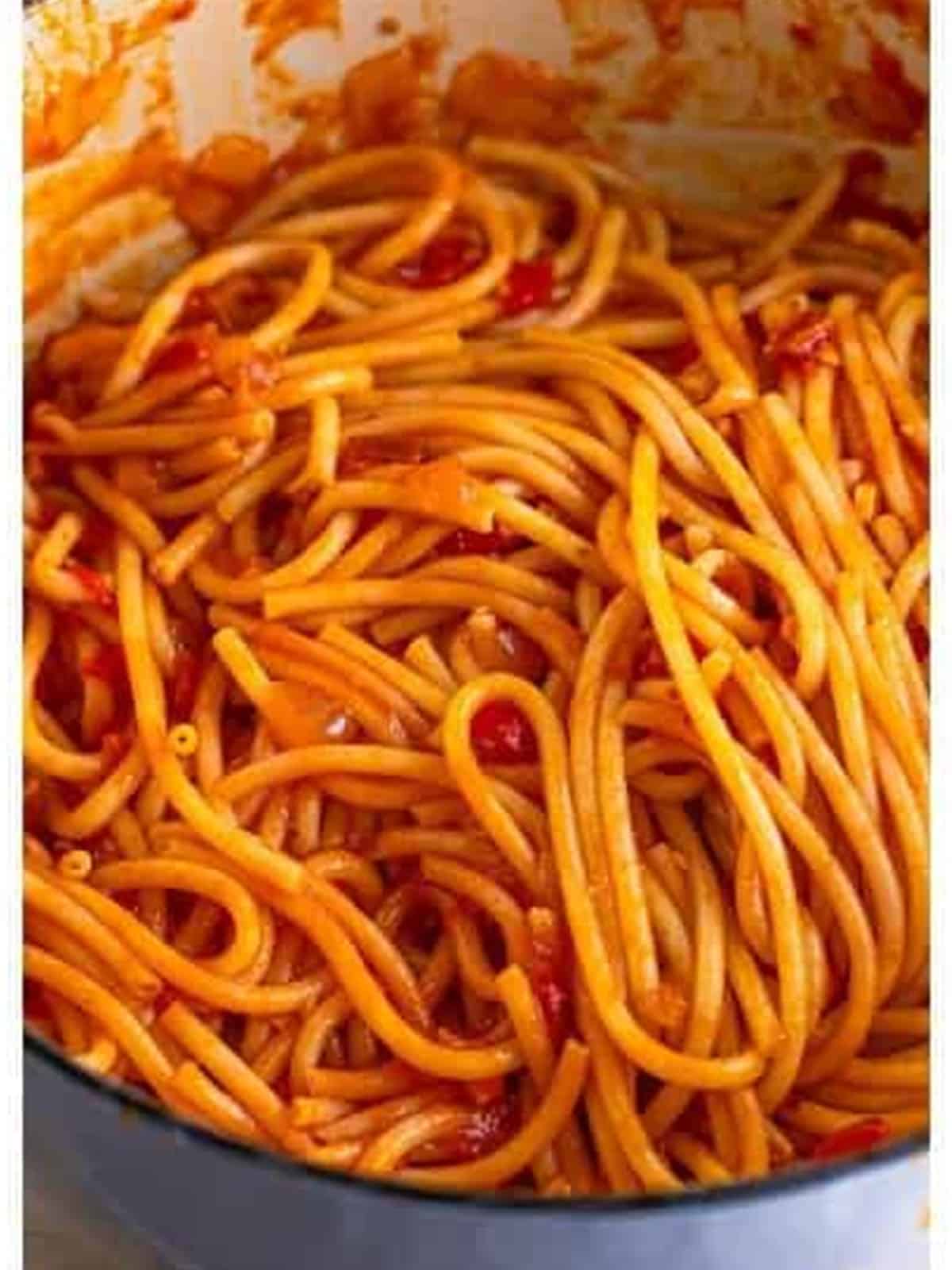 Bucatini tossed in the amatriciana sauce with reserved pasta water until coated.
