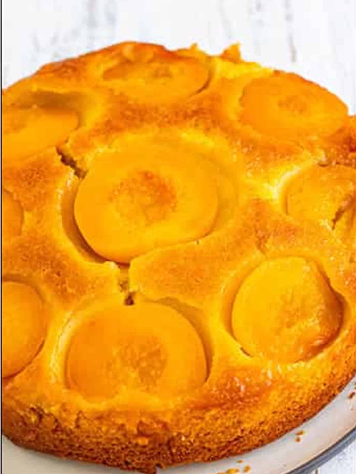 Baked peach upside down cake inverted showing the caramelized peach halves on top