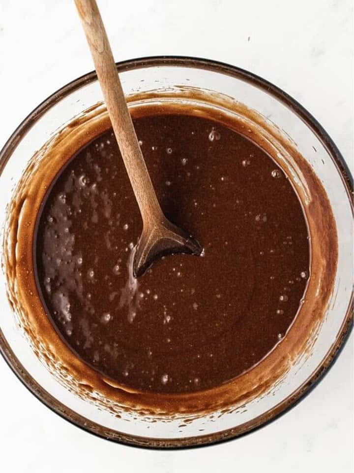 Eggs and vanilla beaten into the chocolate brownie batter.