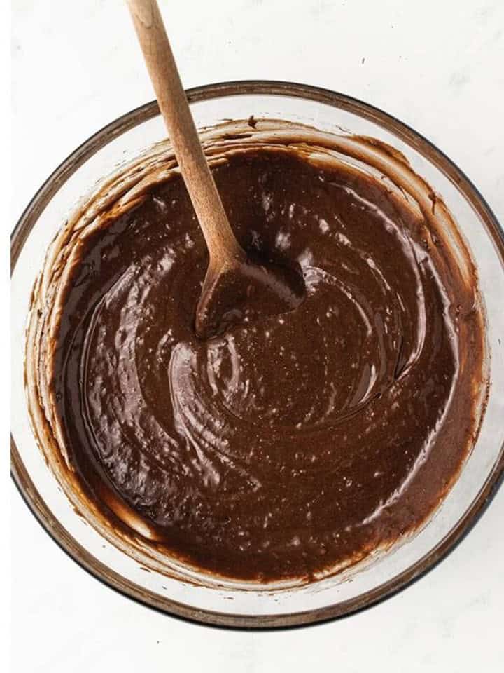 Flour, cocoa powder, and salt folded into the thick brownie batter.
