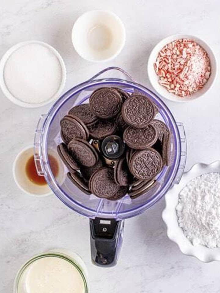 Oreos in the bowl of a food processor for the peppermint cheesecake crust.