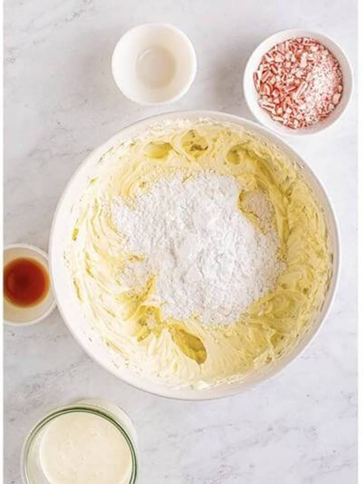 Powdered sugar added to the whipped cream cheese for peppermint cheesecake filling.