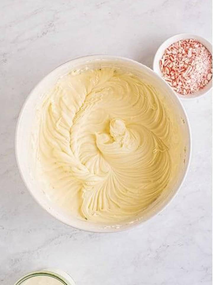 Peppermint cheesecake filling mixed until completely smooth in a white bowl.