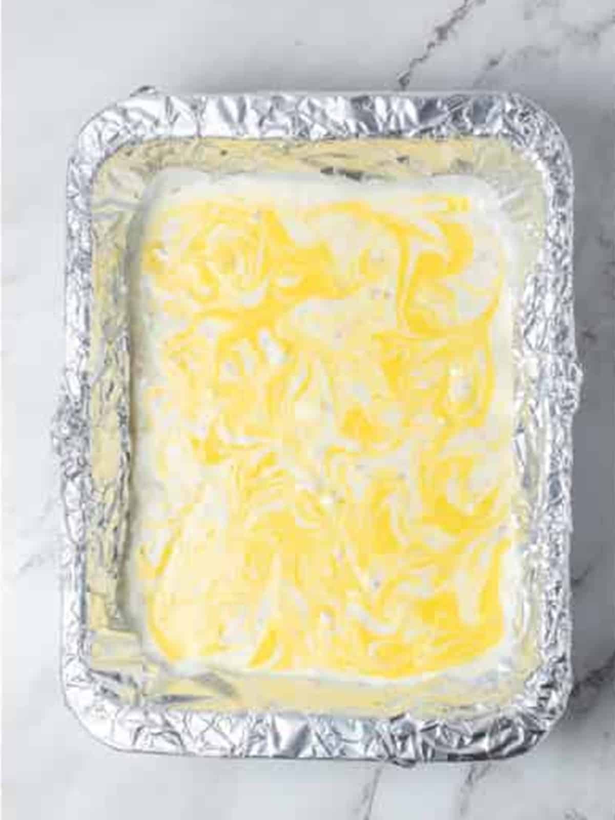 Yellow candy melts swirled through the white almond bark with a toothpick.