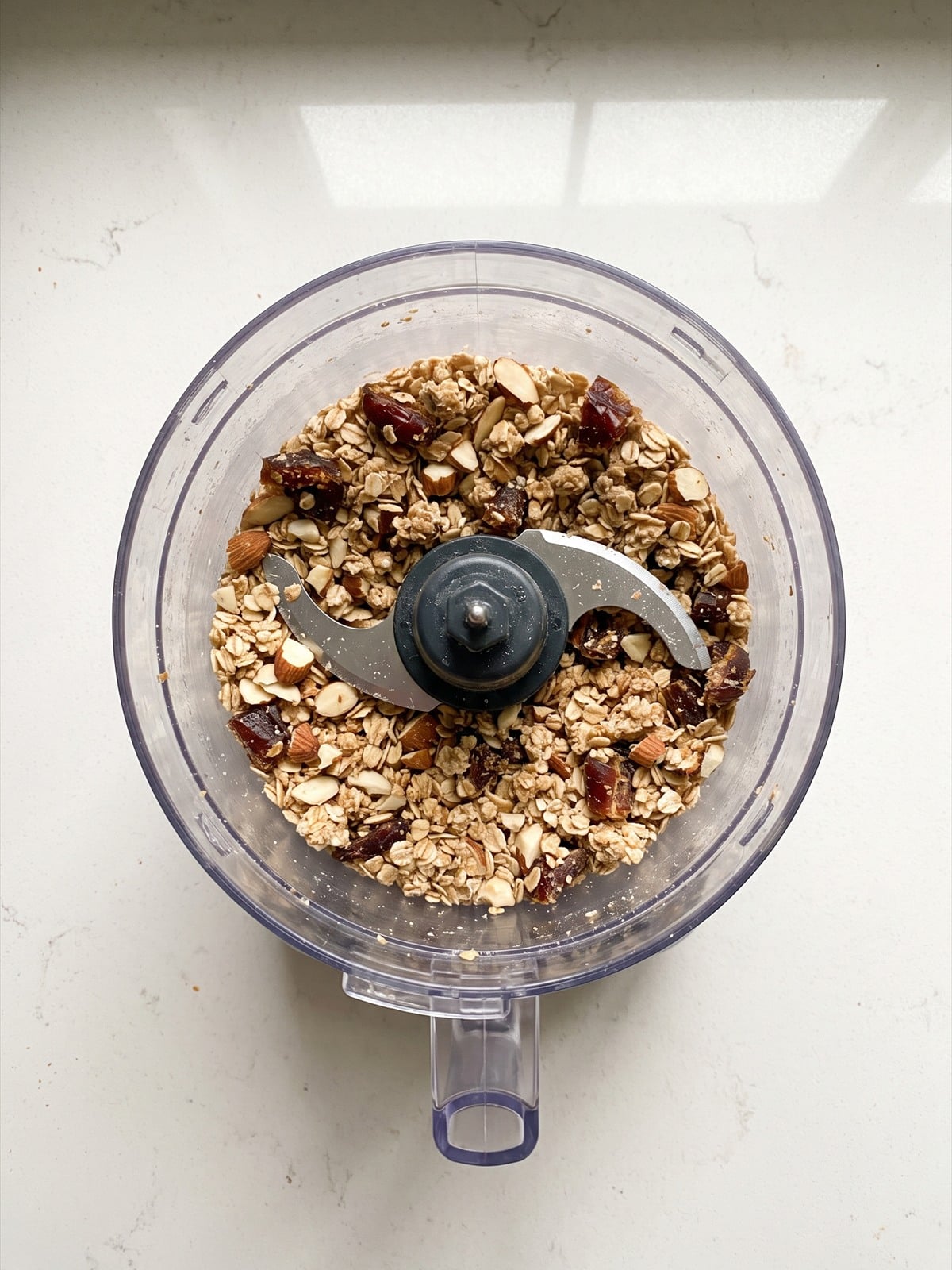 Oats, sliced almonds, and dates pulsed into a coarse crumble topping in a food processor.