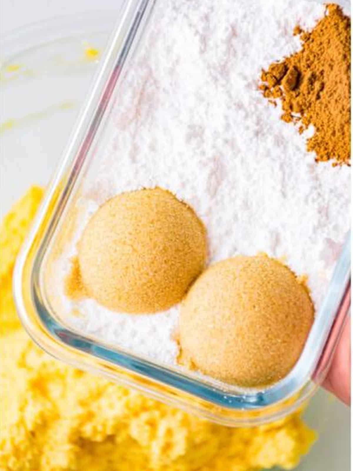 Powdered sugar, brown sugar, and pumpkin pie spice added to the bowl.
